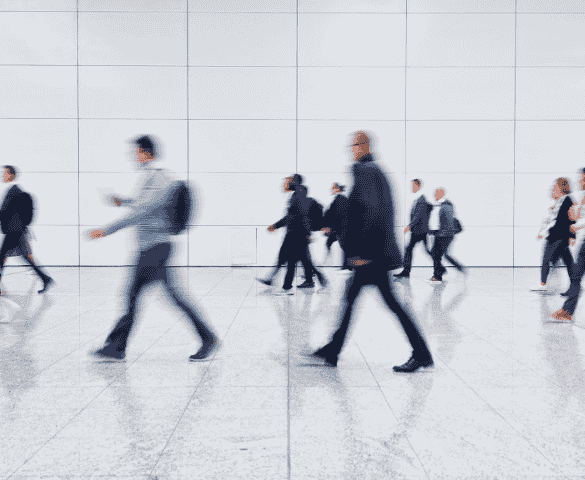 crowds of people walking across a outdoor floor