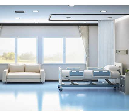 photo of an empty room containing a couch and medical bed with light blue flooring in an Institutional Facility
