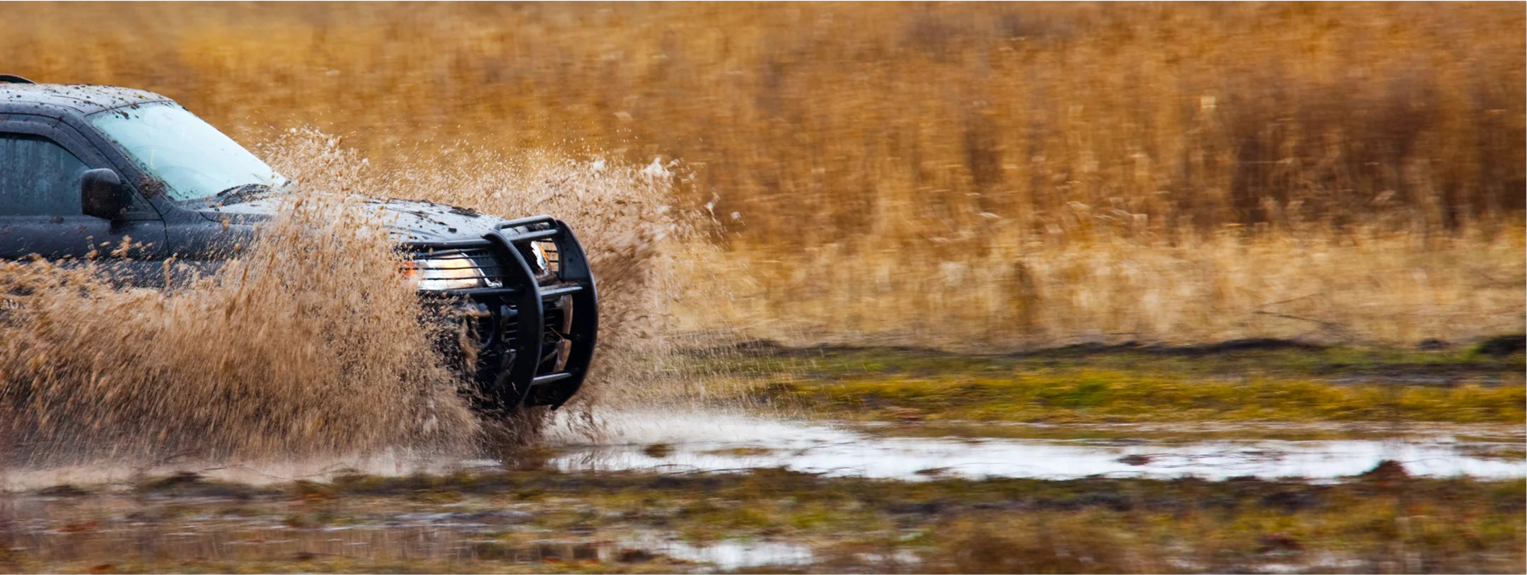 a photo of an american made vehicle, like a jeep, driving off road.