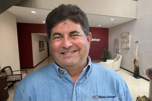 Russell Lewis, Founder of Rhino Linings a photo of Russell Lewis, the founder of Rhino Linings, in the lobby of an office