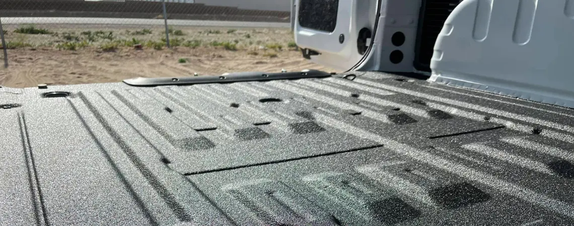 close up image of a truck bed that is coated in Rhino. Linings protective coatings