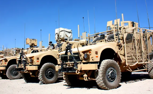 538x330-tan-military-fleet-of-trucks-in-the-desert Tan military fleet of trucks in the desert.