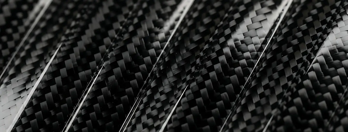 Close-up image of carbon fiber infused with clear resin.