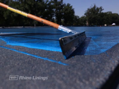 close up of epoxy protective coating spread across reflecting pool concrete